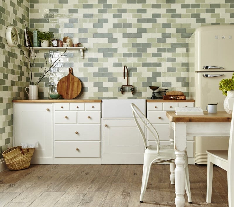Green and cream metro tiles in a country style kitchen