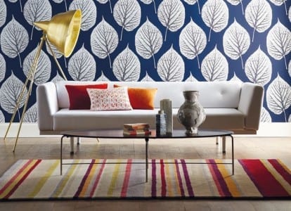 A living room decorated with Wallpaper from the Leaf Momentum Volume 2 collection by Harlequin, featuring a beautiful blue and white design.