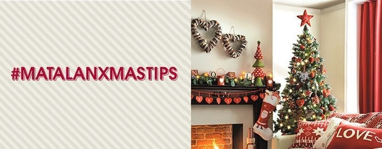 A festive living room adorned in Christmas decorations and featuring a cozy fireplace. Get inspired with MatalanXmasTips!