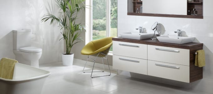 A chic showcase of a bathroom with a white sink, toilet, and tub.
