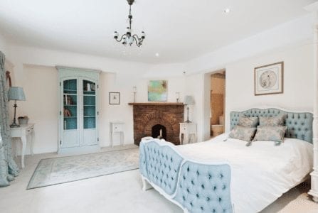 A dream dwelling with blue furniture and a fireplace.