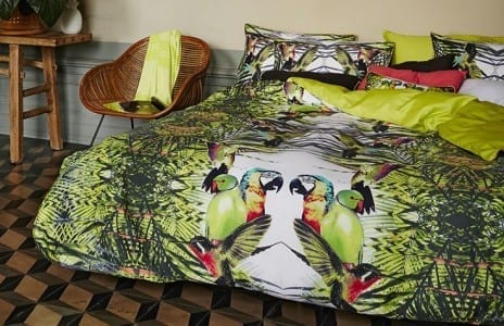 The perfect home for a green and yellow parrot - a bed.