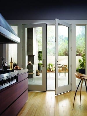 A kitchen with a sliding glass door that brings the outside in.