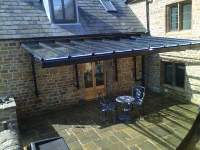 Glass veranda patio area with a table and chairs.