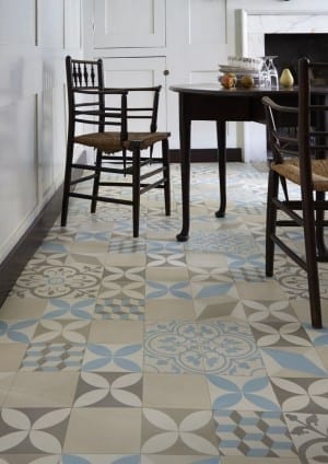 The dining room boasts a trendy patterned flooring, adorned with blue and white tiles.