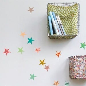 A rented home wall with colorful stars and baskets on it, perfect for personalizing your space.