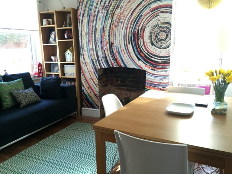 A cozy living room with a table and chairs and a fireplace, perfect for sharing on a home blog.