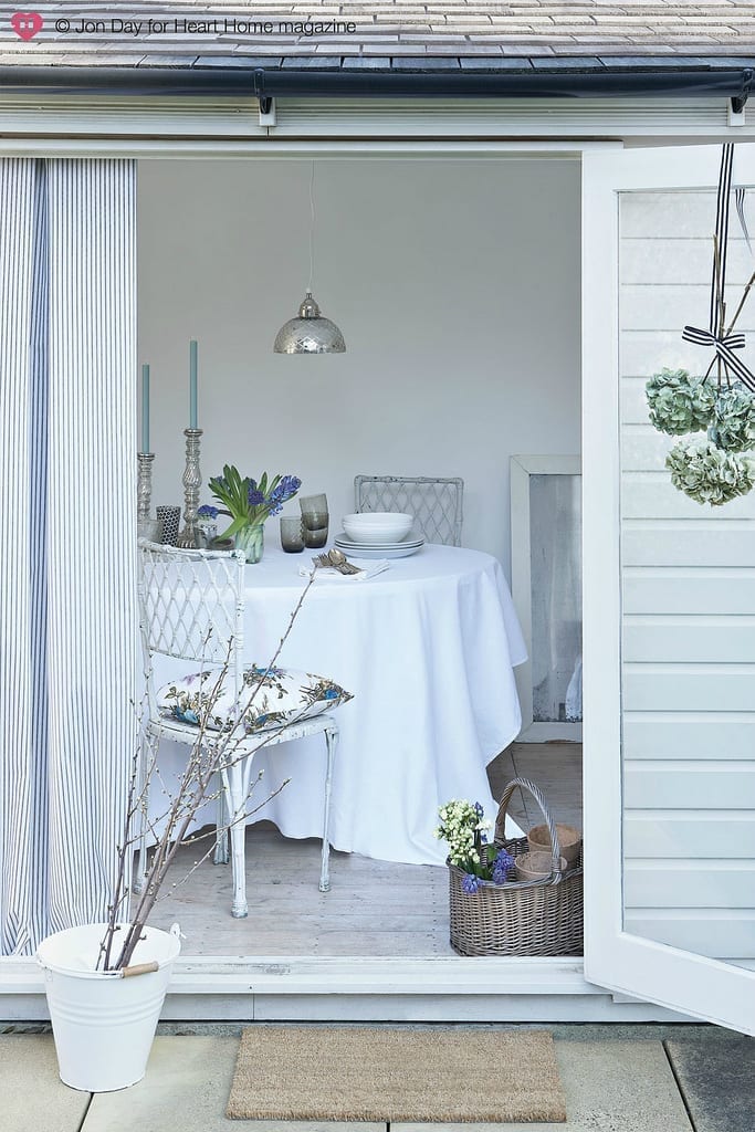 A perfect dining room with a white table and chairs, ideal for a she shed.