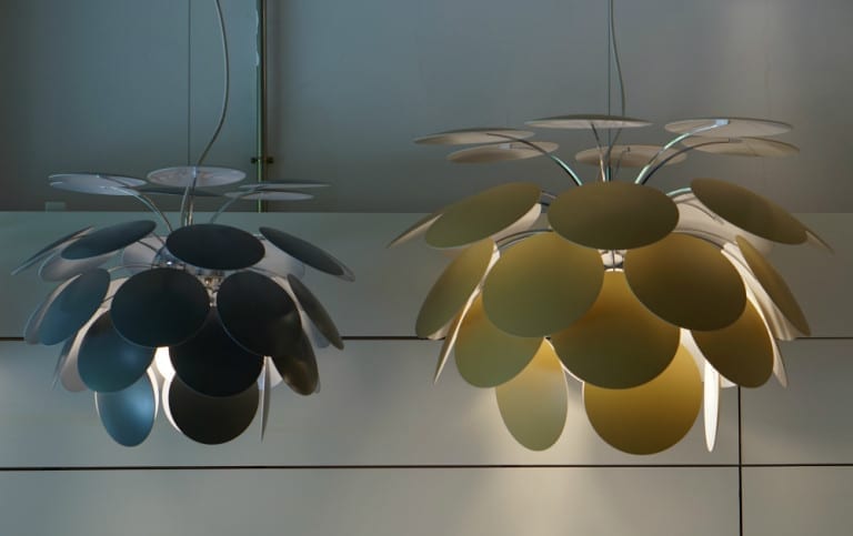 Two pendant lights with a Spanish design hanging from the ceiling.