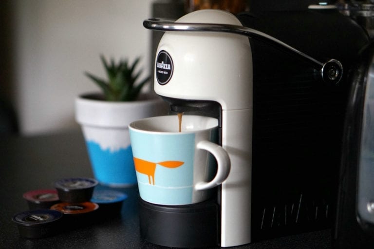 A space-saving kitchen gadget for coffee lovers, featuring a coffee maker with a cup of coffee next to it.