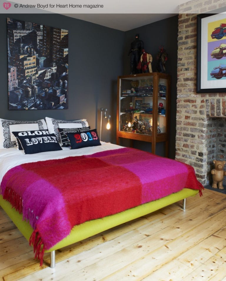         A cosy bed with a colorful blanket to brighten up your bedroom.