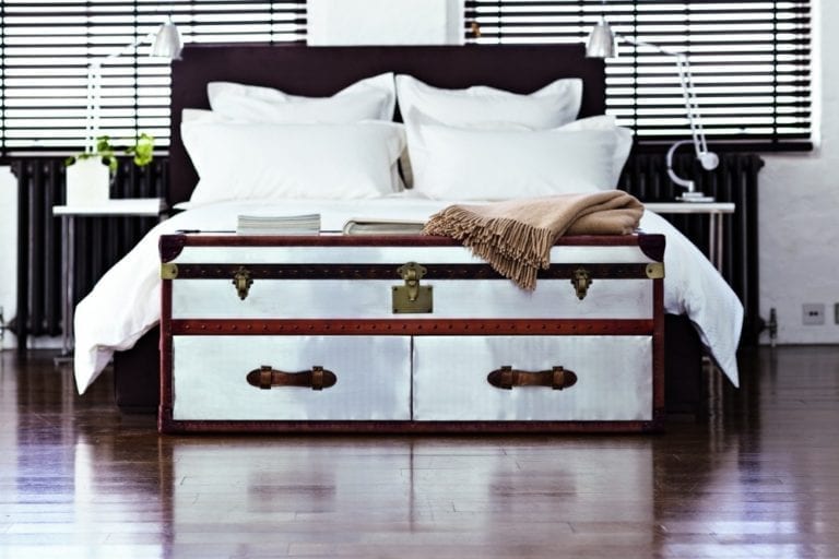 In celebration of an anniversary, Feather & Black is hosting a giveaway featuring an exquisite bed with a trunk positioned in the center of the room.