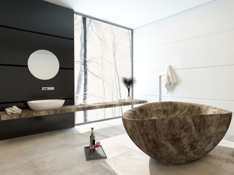 Create a hotel style bathroom with a black and white aesthetic, featuring a marble bathtub.
