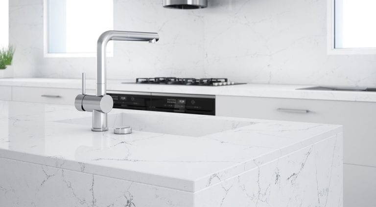 A white kitchen with a quartz counter top, following home trends.