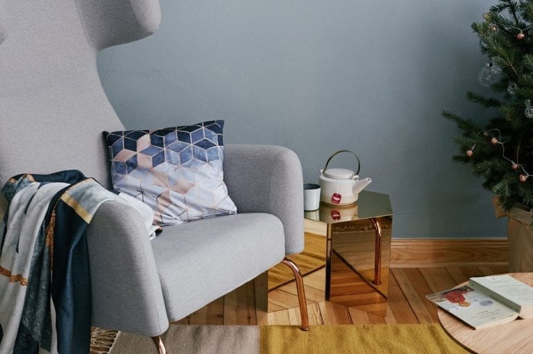 Transform your living room into a festive wonderland with a cozy chair and a beautifully decorated Christmas tree. Add a touch of artistic flair to your space with unique artwork from JUNIQE's