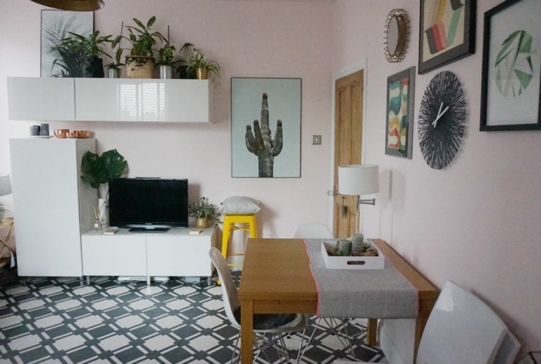 A small living room with a television and plants undergoes a makeover.