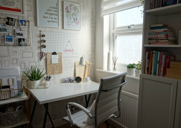 A white desk and chair in a home office, protected against glare with window film.
