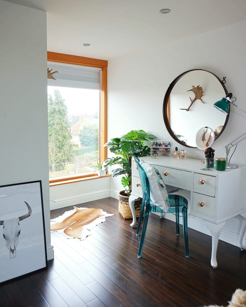 A bedroom with a mirror and a cowhide rug.

Keywords used: none
