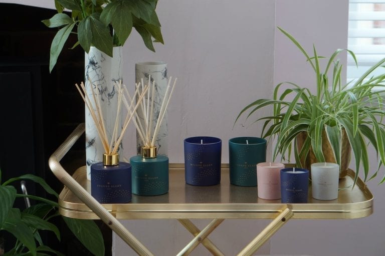 A Wax Lyrical tray with candles and a plant on it, creating a delightful fusion of room fragrance and ornamental appeal.