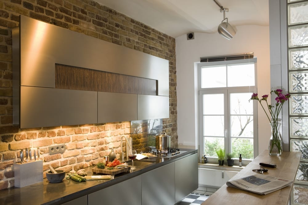 Modern kitchen area with exposed brick slips wall