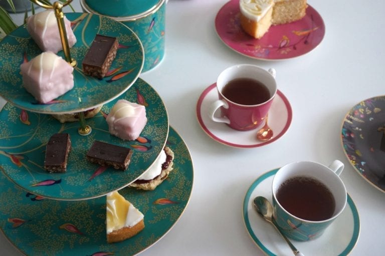 An elegant Afternoon Tea Set with exquisite tea and desserts on Portmeirion plates, designed by Sara Miller London.