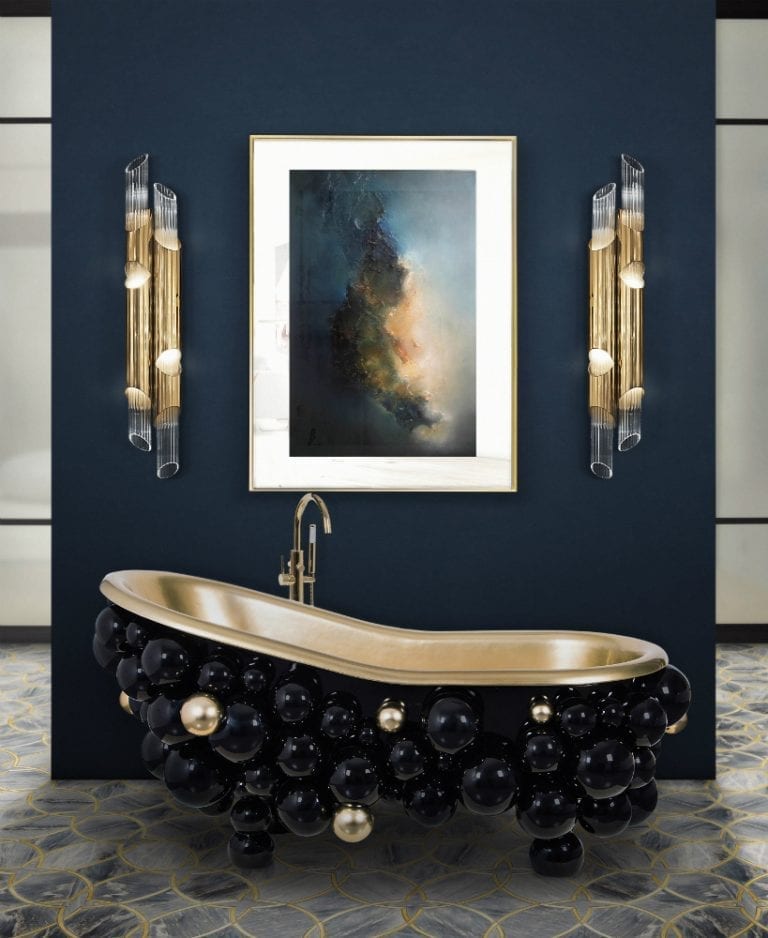 A stylish bathroom with top fittings including a black and gold bathtub and an exquisite painting.