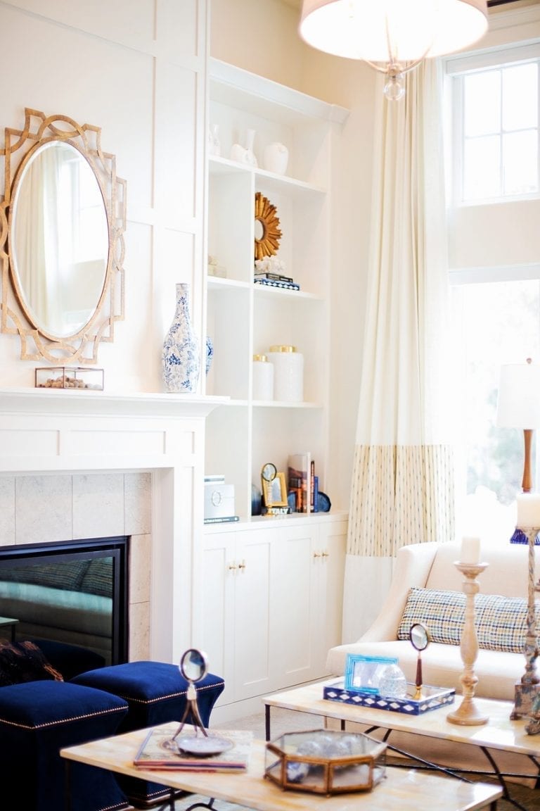 A cozy living room perfect for buyers, featuring a beautiful fireplace and an elegant mirror.