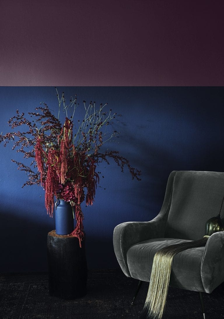 A chair with a vase in front of a purple wall for my painting.