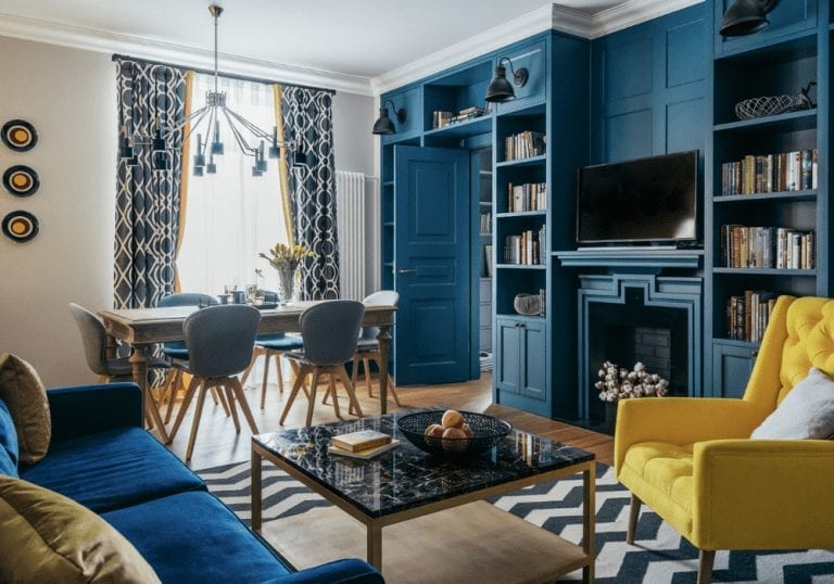 A small home with blue and yellow furniture in the living room.
