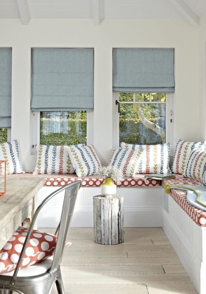 A dining room window seat with a table and chairs is a cozy addition to any home.