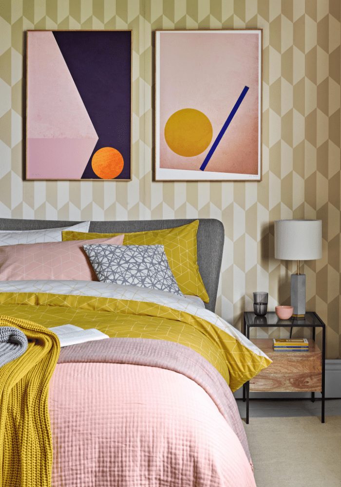 A bedroom in a rented home with a bright yellow and pink color scheme.