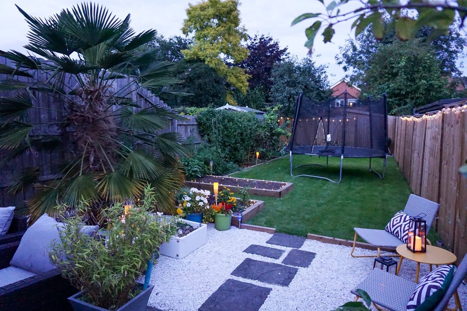 A small garden with contemporary furniture and garden lighting.