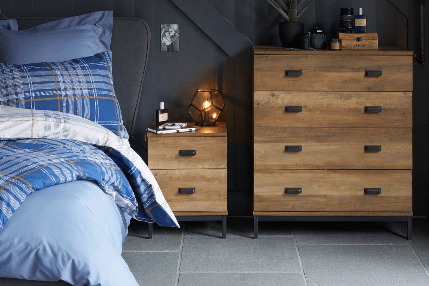Small bedroom with a bed, dresser, and chest of drawers.