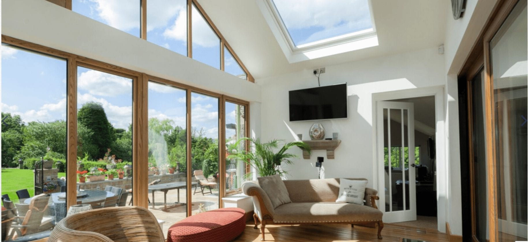 A living room with large windows and skylights is perfect for enjoying natural light throughout the day.