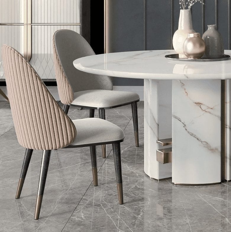 Transform your dining room into a luxurious space with a marble table and chairs from Juliette's Interiors.