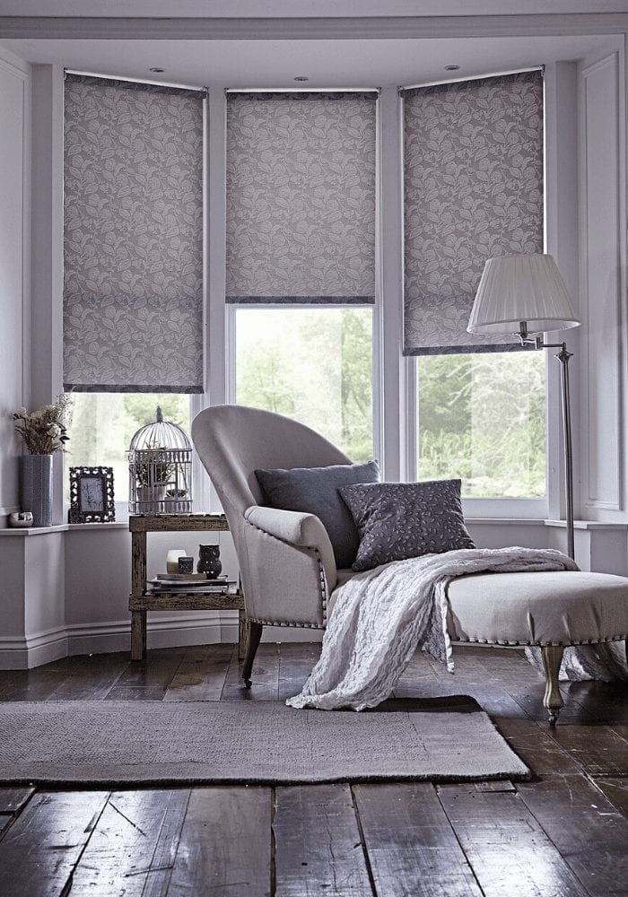 Grey roller blinds in a home interiors setting.