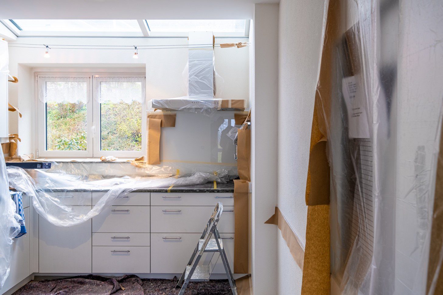A home refurbishing project is underway in the kitchen, with surfaces covered for protection to keep neighbours happy.