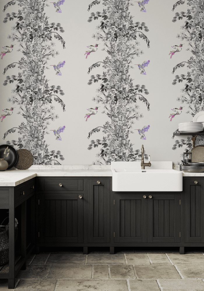 A budget-friendly modern kitchen with dark cabinetry and a farmhouse sink against a floral wallpaper backdrop.