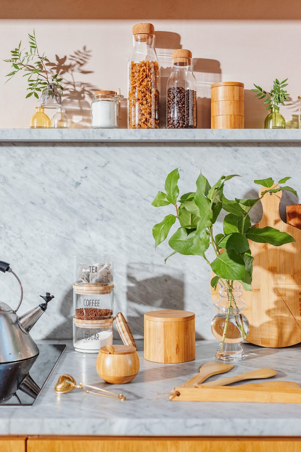 Wooden storage canisters on marble shelves - best kitchen trends 2022