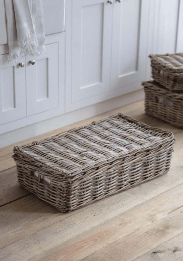 wicker basket on a wooden floor in a simple bedroom