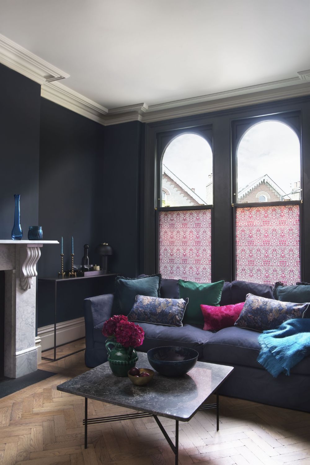 Elegant living room with dark walls, a large window, colorful accents, and ready to buy a house.