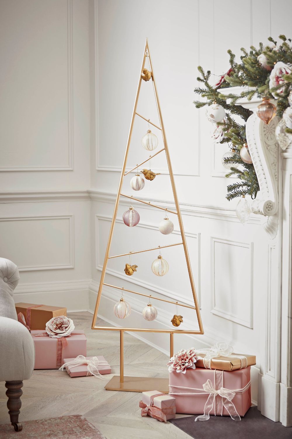 Gold, flat miminal 2d Christmas tree decorated with a few gold and white baubles, perfect in a smaller home