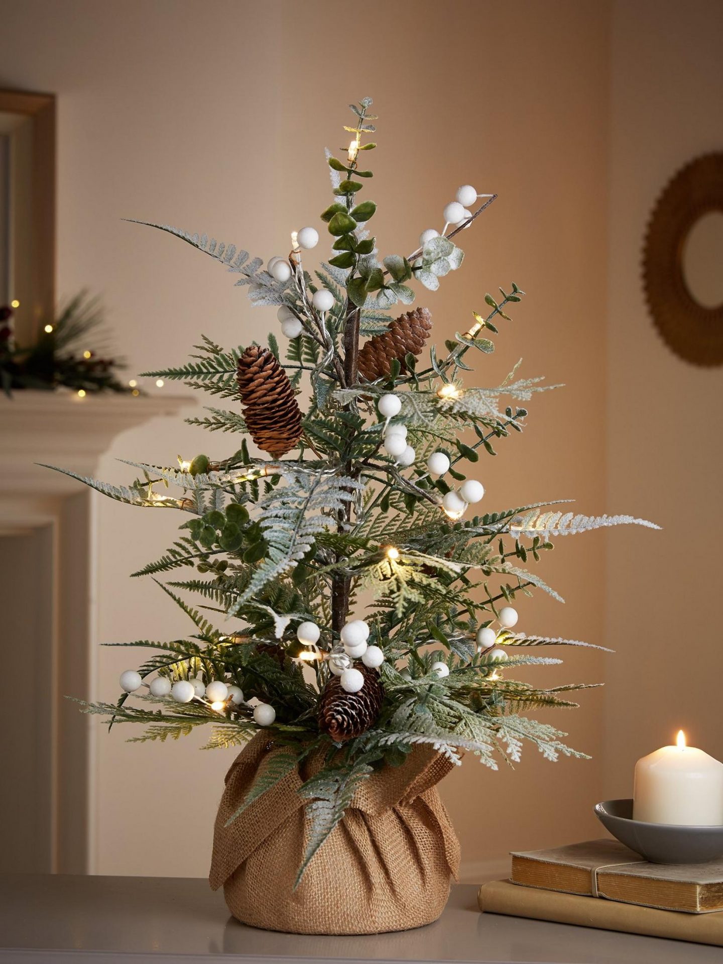 Traditional small Christmas tree in a rustic sack on a tabletop