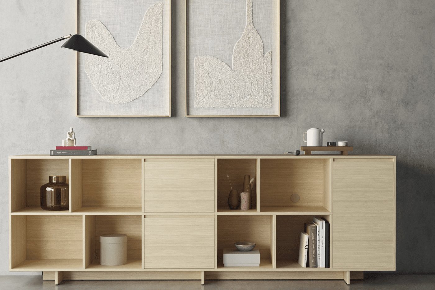 A modern living room featuring a light wooden sideboard from our home furniture buying guide, decorative framed bird artwork, and minimalistic decor items.