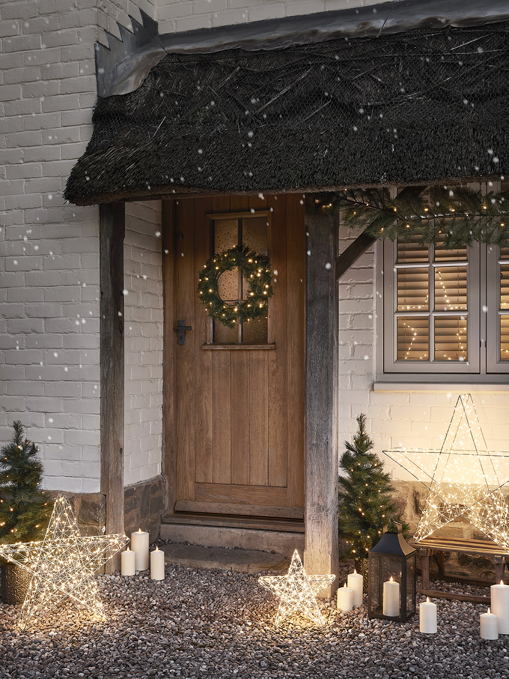 A festive house transformed with lights and candles.