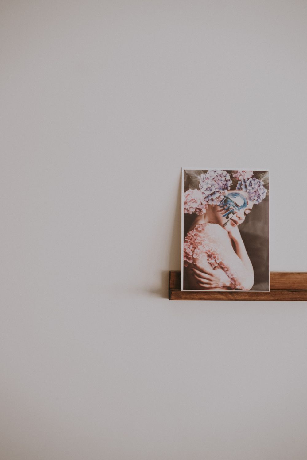 An acrylic photo of a woman on a wooden shelf, perfect for home decor.
