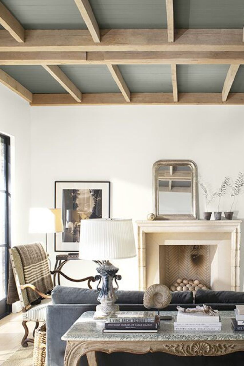 A warm and cosy living room with a fireplace and a grey couch.