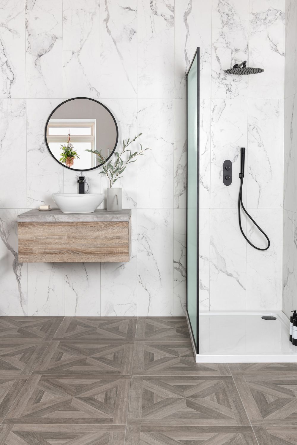 A bathroom with a luxurious look, featuring a marble floor and white walls.