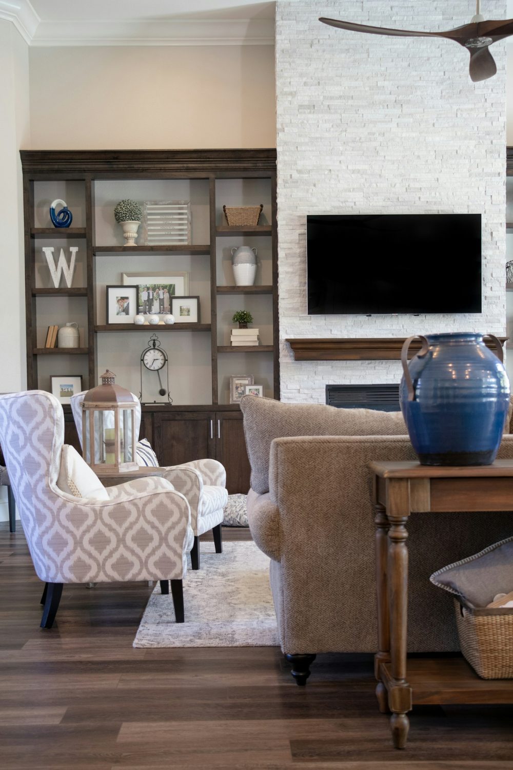 A living room with hardwood floors and a ceiling fan, perfect for older relatives