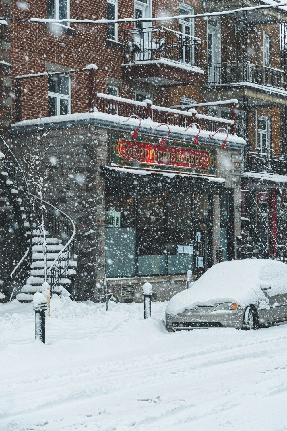 A man is walking down a snow-covered walkway.